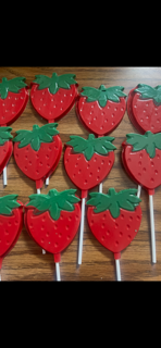 Red strawberry-shaped sweet treats on sticks